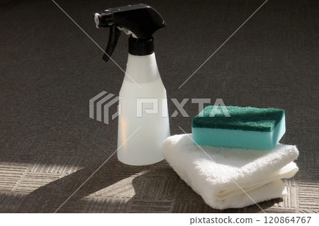 A spray bottle filled with cleaning detergent, a cloth and a sponge 120864767