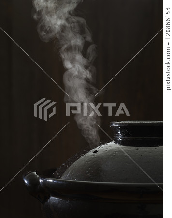 Image of hot pot cooking with steam rising from the clay pot Image of hot pot cooking with steam rising from the clay pot 120866153