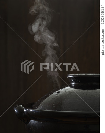 Image of hot pot cooking with steam rising from the clay pot 120866154