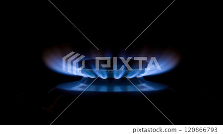 Blue gas flame burning on stove in dark background, high gas prices, natural fuel use, household expenses, and energy crisis, representing economy, heating, resource management 120866793