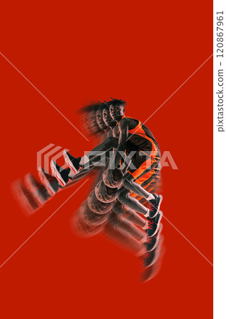 Basketball player mid-air holding ball, bold red background. Stroboscopic effect enhances dynamic phases of jump, focusing on strength and action. 120867961