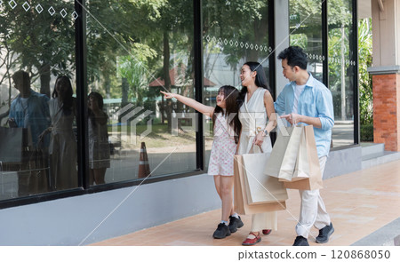 Happy Family Shopping Together Parents and Children Enjoying a Day Out with Shopping Bags and Smiles Happy Family Shopping Together Parents and Children Enjoying a Day Out with Shopping Bags and Smiles 120868050