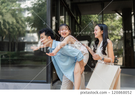 Happy Family Enjoying a Day of Shopping Together with Smiles and Laughter in a Modern Urban Setting Happy Family Enjoying a Day of Shopping Together with Smiles and Laughter in a Modern Urban Setting 120868052