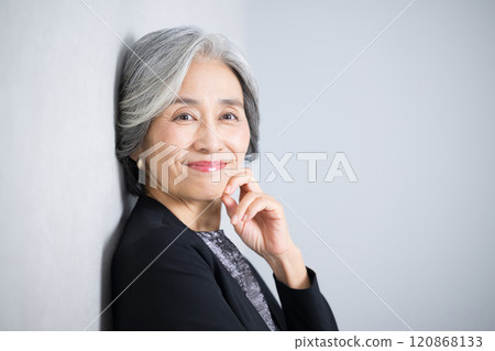 照片中,一位頭髮花白、穿著西裝、手托下巴看著鏡頭思考的照片。 照片中,一位頭髮花白、穿著西裝、手托下巴看著鏡頭思考的照片。 120868133