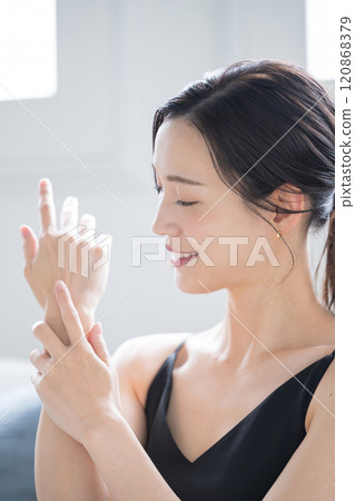 Beautiful woman applying cream to treat rough and dry hands in winter. Close-up image of hands Beautiful woman applying cream to treat rough and dry hands in winter. Close-up image of hands 120868379