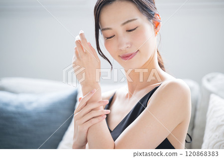 Beautiful woman applying cream to treat rough and dry hands in winter. Close-up image of hands Beautiful woman applying cream to treat rough and dry hands in winter. Close-up image of hands 120868383