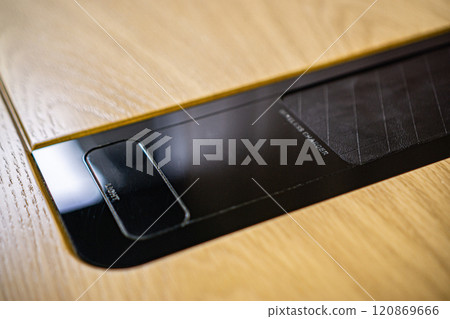 Mobile phone with wireless charger on table. Modern workplace accessory Mobile phone with wireless charger on table. Modern workplace accessory 120869666