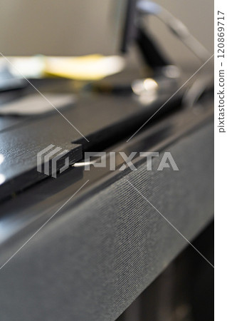 Mobile phone with wireless charger on table. Modern workplace accessory 120869717