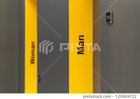 Perspective of a long corridor in office building. Doors of washrooms in hallway. Doors in office with wc signs. Entrance to restrooms in a factory Perspective of a long corridor in office building. Doors of washrooms in hallway. Doors in office with wc signs. Entrance to restrooms in a factory 120869722