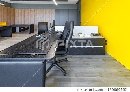 Modern office space with tables and chairs, computers and office supplies with no employees Modern office space with tables and chairs, computers and office supplies with no employees 120869762
