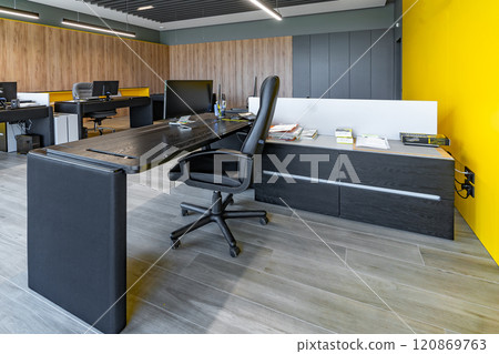 Modern office space with tables and chairs, computers and office supplies with no employees Modern office space with tables and chairs, computers and office supplies with no employees 120869763