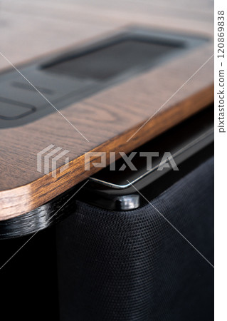 Mobile phone with wireless charger on table. Modern workplace accessory 120869838