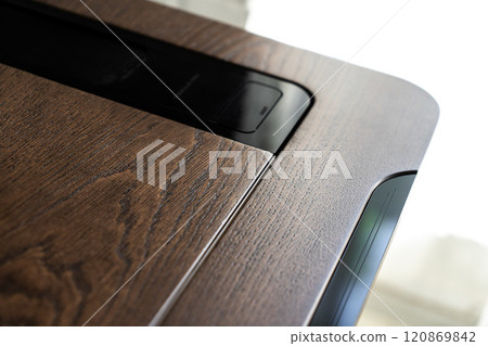 Mobile phone with wireless charger on table. Modern workplace accessory 120869842