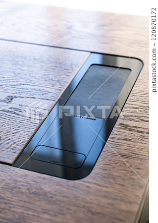Mobile phone with wireless charger on table. Modern workplace accessory Mobile phone with wireless charger on table. Modern workplace accessory 120870172