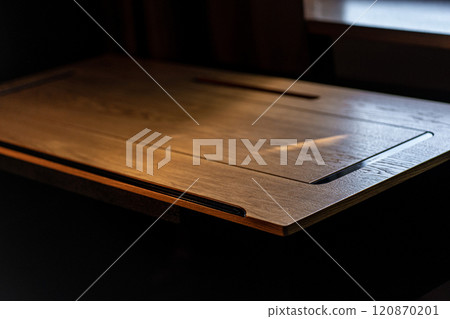Mobile phone with wireless charger on table. Modern workplace accessory 120870201