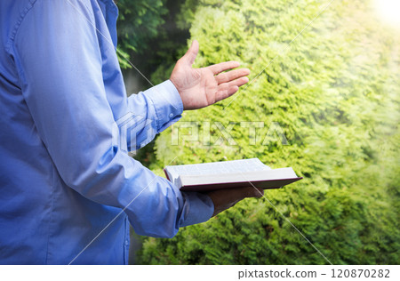 Old man with a bible in his hand 120870282