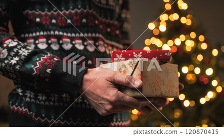 Man holds gift package for Christmas Holidays  120870415