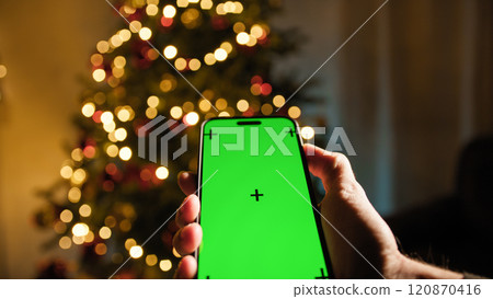smartphone with green screen under Christmas tree 120870416