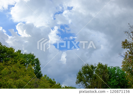 Blue sky peeking through the clouds 120871156