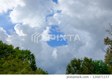Blue sky peeking through the clouds 120871157