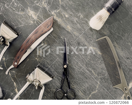 On a grey marble surface are old barber tools. Vintage manual hair clipper comb razor shaving brush shaving brush hairdressing scissors. top view. flat lay. On a grey marble surface are old barber tools. Vintage manual hair clipper comb razor shaving brush shaving brush hairdressing scissors. top view. flat lay. 120872066
