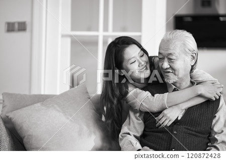 elderly asian father and adult daughter conversing at home elderly asian father and adult daughter conversing at home 120872428