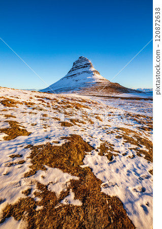 Kirkjufell mountain at sunrise, with snow foreground, Iceland 120872638
