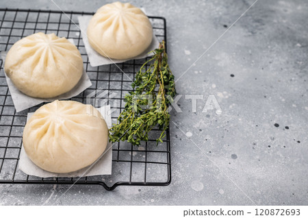 Baozi Bun, Chinese Steamed bun with meat. grey background. top view Baozi Bun, Chinese Steamed bun with meat. grey background. top view 120872693