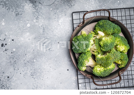 Green fresh broccoli pieces in a steel tray. grey background. top view 120872704