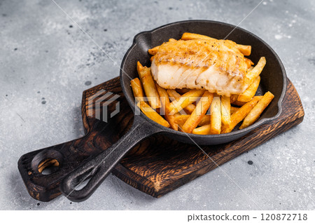British fish and chips with fried cod fillet and French fry potato in skillet. grey background. top view 120872718