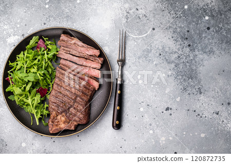 Barbecue dry aged wagyu entrecot steak on plate with salad. grey background. top view 120872735