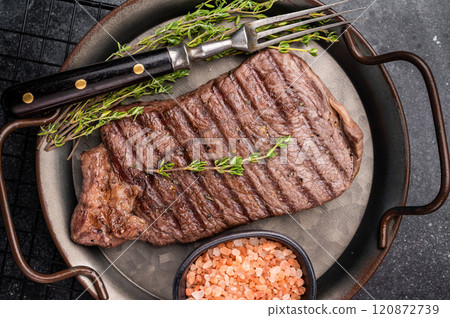BBQ roasted beef Rump steak on steel tray. black background. top view BBQ roasted beef Rump steak on steel tray. black background. top view 120872739