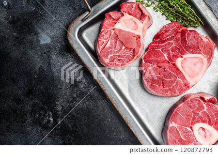 Fresh Raw Osso buco Veal steak, cross cut veal shank Ossobuco. Black background. Top view. Copy space 120872793