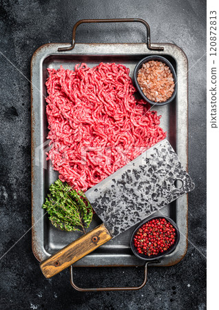 Unccoked Mince Ground meat, raw mincemeat beef and pork in a kitchen tray. Black background. Top view Unccoked Mince Ground meat, raw mincemeat beef and pork in a kitchen tray. Black background. Top view 120872813
