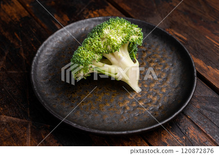 Fresh broccoli cabbage pieces on a plate. wooden background. top view 120872876