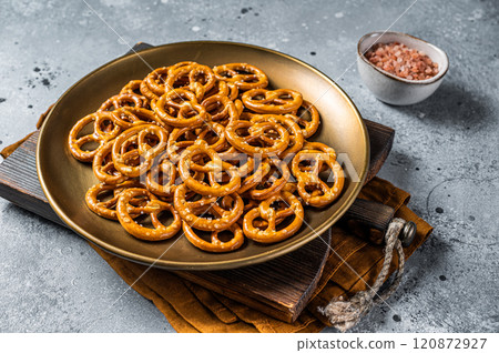 Mini pretzels crackers with salt. Gray background. Top view Mini pretzels crackers with salt. Gray background. Top view 120872927
