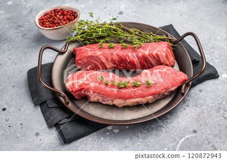 Raw Tri Tip Steak from Black Angus beef meat in stell tray. grey background. top view Raw Tri Tip Steak from Black Angus beef meat in stell tray. grey background. top view 120872943