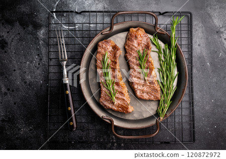BBQ roast marbled beef Steak, beef meat on tray with herbs. black background. top view BBQ roast marbled beef Steak, beef meat on tray with herbs. black background. top view 120872972