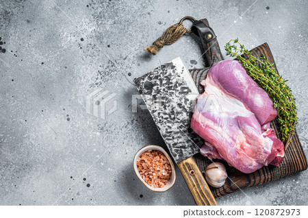 Poultry fresh meat, Raw Turkey thigh fillet on wooden cutting board. Gray background. Top view. Space for text 120872973