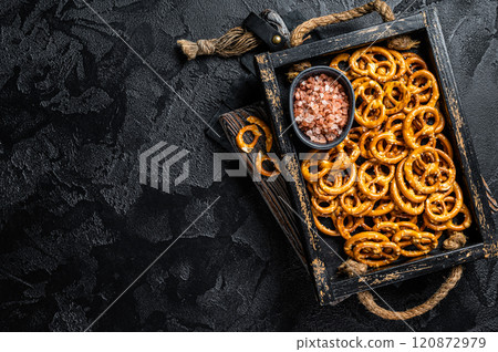 Snack box with salty pretzels crackers. Black background. Top view. Copy space 120872979