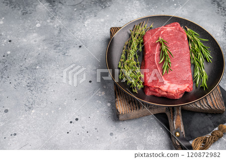 Raw Top sirloin beef steak with herbs. wooden background. top view 120872982