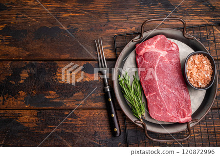 Ready for cooking Raw Rump beef steak with herbs. wooden background. top view 120872996
