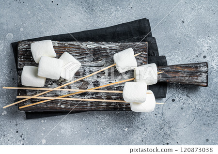 Marshmallow on the stick ready for BBQ. Gray background. Top view Marshmallow on the stick ready for BBQ. Gray background. Top view 120873038