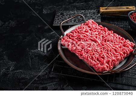 Raw beef and lamb Minced Meat, fresh ground meat. Black background. Top view. Space for text 120873040