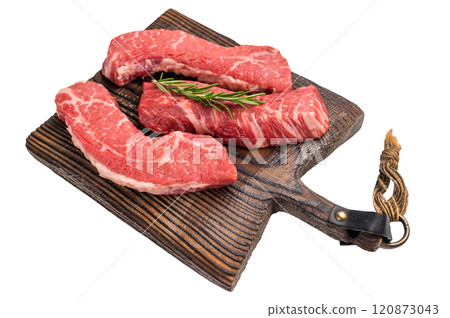 Raw marbled beef Steak, beef meat on wooden board with herbs isolated on white background Raw marbled beef Steak, beef meat on wooden board with herbs isolated on white background 120873043