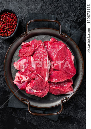 Raw Lamb leg steaks on butcher table. Black background. Top view 120873118