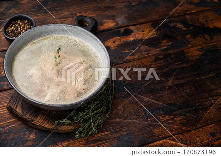 Bowl of clear chicken broth with meat. wooden background. top view 120873196