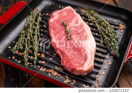 Fresh strip loin beef steak, striploin steak on a grill pan wooden background. top view Fresh strip loin beef steak, striploin steak on a grill pan wooden background. top view 120873197