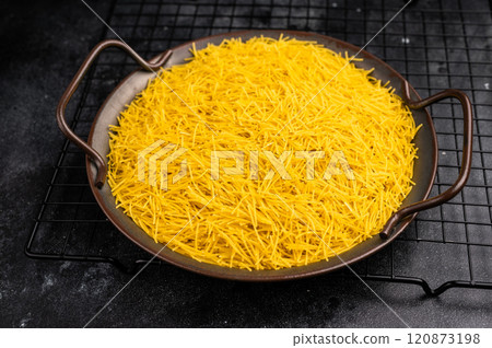 Raw Vermicelli, uncooked pasta in a tray. black background. top view Raw Vermicelli, uncooked pasta in a tray. black background. top view 120873198
