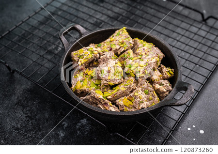 Oriental Halva with pistachio in a skillet. Natural vegan sweets. black background. top view. Oriental Halva with pistachio in a skillet. Natural vegan sweets. black background. top view. 120873260